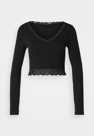Black long-sleeve crop top with a V-neck, featuring a scalloped lace trim around the neckline and at the hem. Soft, stretchy fabric.
