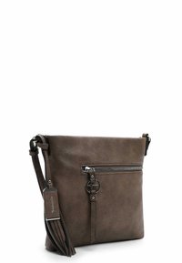 Brown leather crossbody bag with a zippered front pocket, fringe detail on the side, and metallic hardware accents.