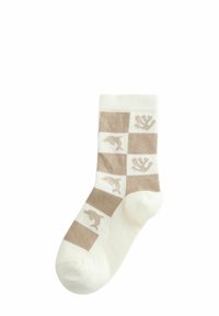 Cremefarvet sok med et ternet mønster i beige, med dyresilhuetter i skiftende felter. Lavet af blødt stof med en ribbet kant.