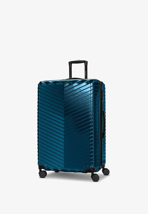 Großer Hartschalenkoffer mit diagonalen Rillen, dunkel-türkisfarben, vier Spinner-Rollen und einem ausziehbaren schwarzen Griff.