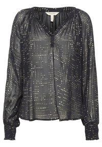 Blusa nera trasparente con motivo a pois argentati, scollo a V e maniche lunghe con polsini arricciati. Tessuto leggero per una vestibilità fluida.