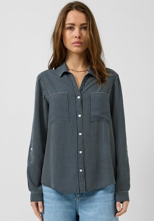 Striped button-up shirt in navy and white, featuring a collar, two chest pockets, and long sleeves with button cuffs; smooth fabric.