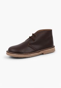 Stivale alla caviglia in pelle marrone con punta rotonda, dettagli cuciti e design con lacci; presenta una suola in gomma beige per grip e comfort.