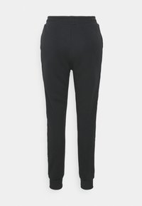 Svarta sweatpants i mjukt tyg, med smal passform, elastisk midja och muddar, samt sidopaneler som detaljer.