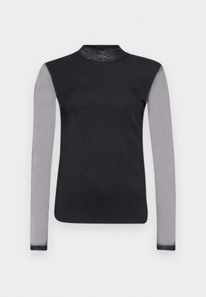 Mustaga pikkade varrukatega topp, millel on liibuv kaelus, hallid läbipaistvad varrukad ja siledast mustast kangast kereosa. Kujundus on liibuva siluetiga.