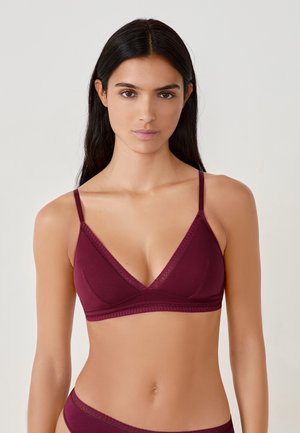 Burgundy wireless bra with triangular cups, thin adjustable straps, and lace trim along the edges. Smooth fabric with a soft texture.
