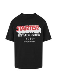 Juodas medvilninis marškinėliai trumpomis rankovėmis, su drąsiais baltais ir raudonais užrašais ant nugaros: "STARTER ESTABLISHED 1971 Ieškok žvaigždės."