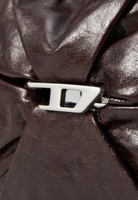 Dark brown leather material with a gathered design secured by a silver D-shaped metal buckle.