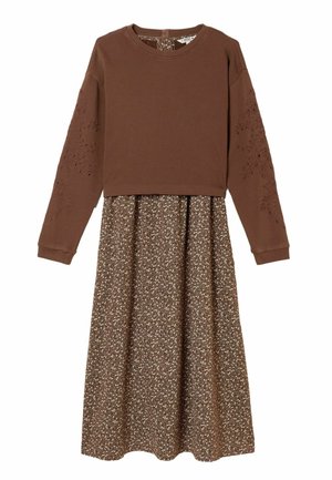 Brown sweater top with long sleeves, featuring embroidered details. Flowy brown floral skirt with a lighter floral pattern below.