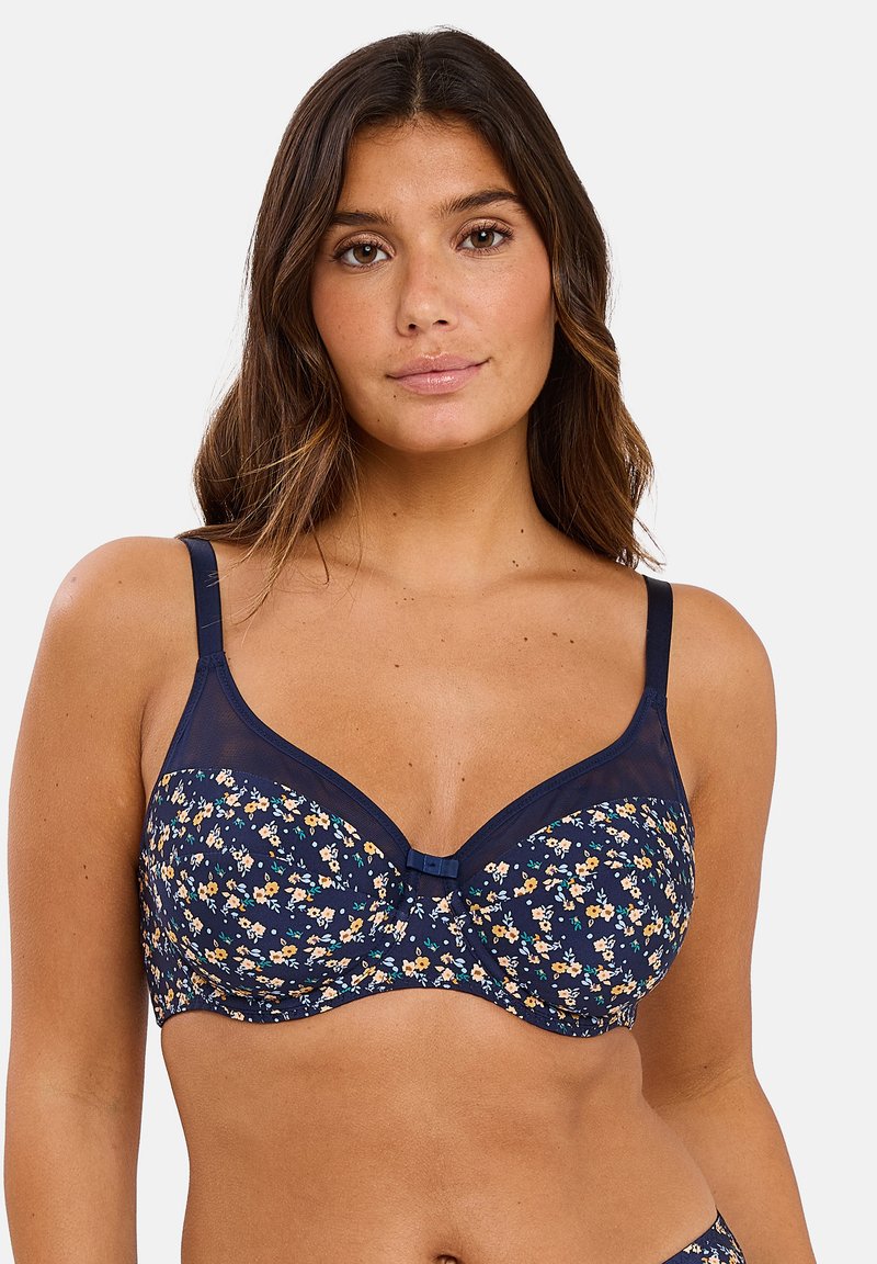 Sostén de estampado floral navy con aros, acentos de malla y tirantes ajustables; presenta un pequeño detalle de lazo en el centro.