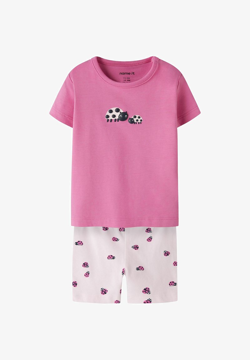 Vaikams rinkinys: rožinis trumpomis rankovėmis marškinėlis su dviem juodai baltomis boružėlėmis ir balti šortai su mažomis rožinėmis boružėlėmis.