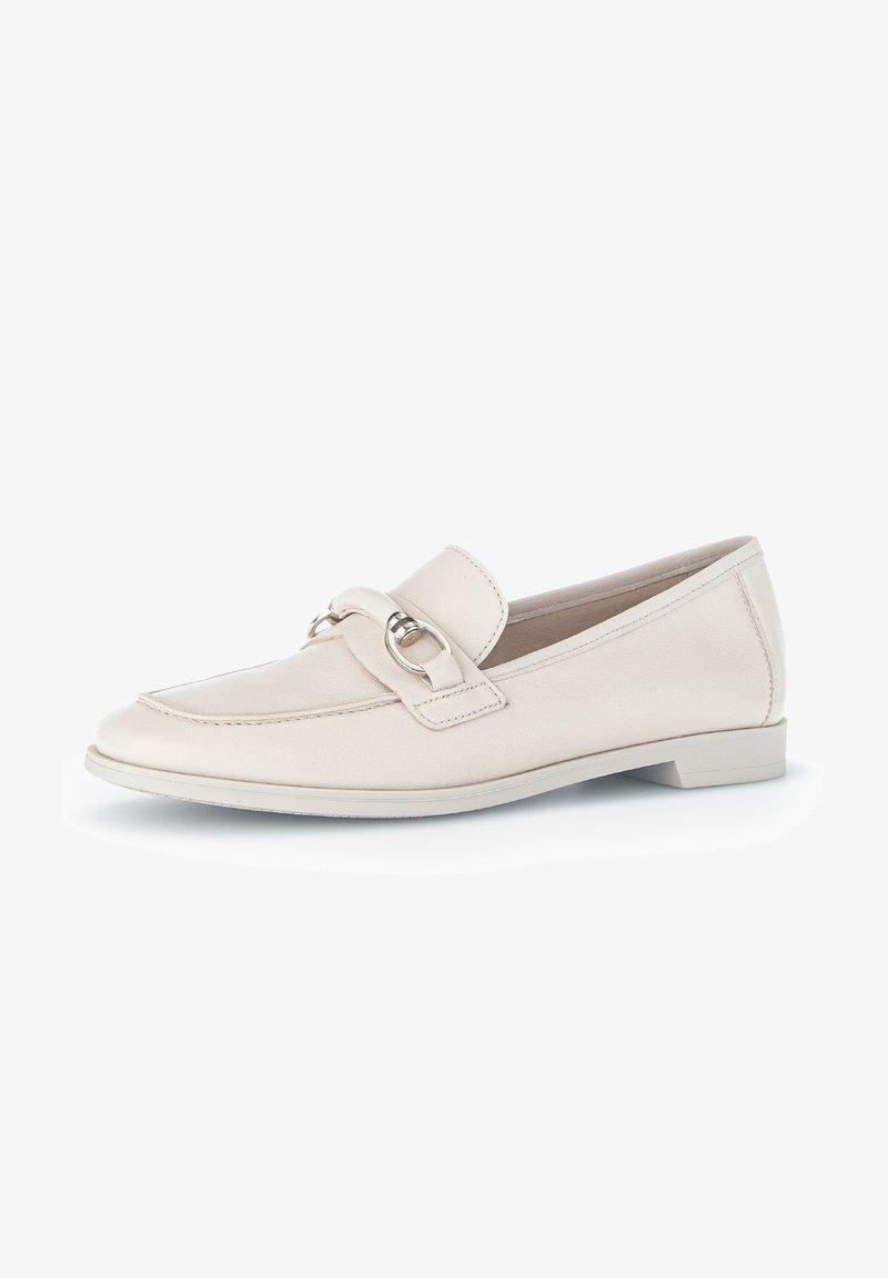 Beige leather loafers with a rounded toe, featuring a decorative strap and circular metal accent, on a low, flat sole.