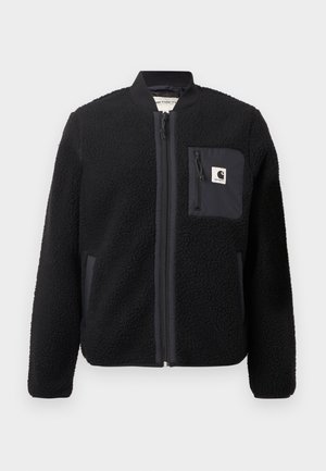 Chaqueta bomber de forro polar negra con cierre de cremallera frontal, puños acanalados y un bolsillo en el pecho. Presenta un tejido texturizado y diseño de color sólido.