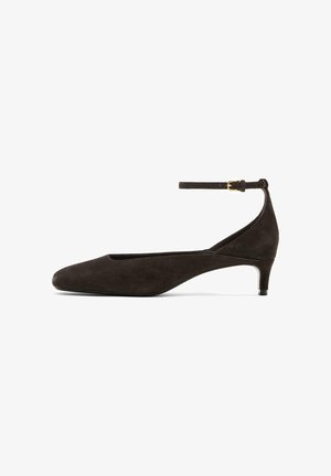 Black suede women's low-heeled shoe with pointed toe and ankle strap with gold buckle, shown in side profile on white background.