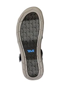 Teva sandal sole featuring a black textured bottom with a honeycomb pattern and white accents, labeled with blue "Teva" branding.