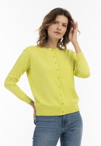 Cardigan verde lime realizzato in morbido tessuto, con scollatura rotonda, bottoni frontali e polsini a costine con orlo aderente.