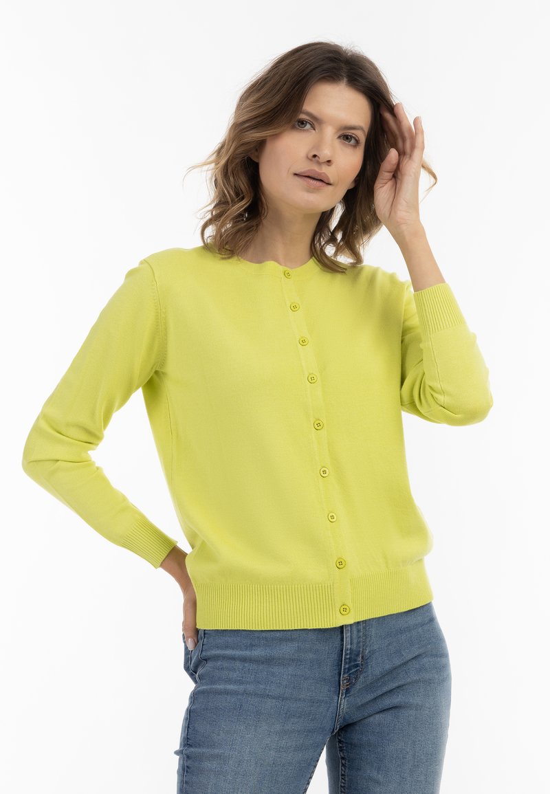 Cardigan verde lime realizzato in morbido tessuto, con scollatura rotonda, bottoni frontali e polsini a costine con orlo aderente.