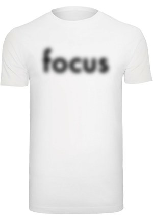 White cotton t-shirt with short sleeves featuring the word "focus" in a blurred black font across the chest. Simple, unembellished design.