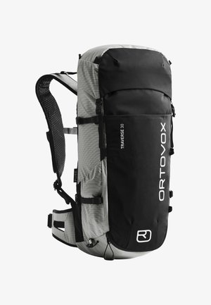 ORTOVOX Traverse 30 backpack, featuring a black top, grey grid-patterned body, adjustable straps, and side pockets for accessories.