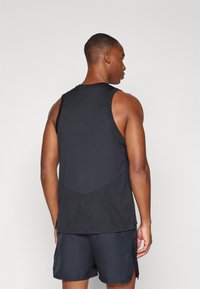 Nike Performance COURT SLAM TANK  - Top - black/light wild mango