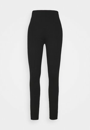 Leggings noirs taille haute, longueur intégrale, coupe slim, présentés sur un fond blanc uni.