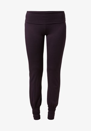 Pantalon de jogging noir ajusté avec taille large et poignets élastiques froncés aux chevilles sur fond blanc.