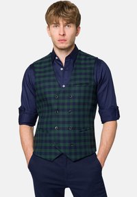 Zielono-granatowa kamizelka w kratę o dopasowanym kroju, z podwójnym zapięciem z przodu, dwoma kieszeniami oraz granatową koszulą pod spodem.