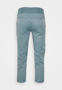 Ljusblå leggings med resårmidja, med en slät textur och bakfickor, designade för komfort och rörlighet.