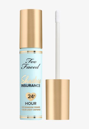 Light blue tube with gold accents and a gold cap. Contains a white applicator wand. Text displays "Shadow Insurance" and "24+ Hour."