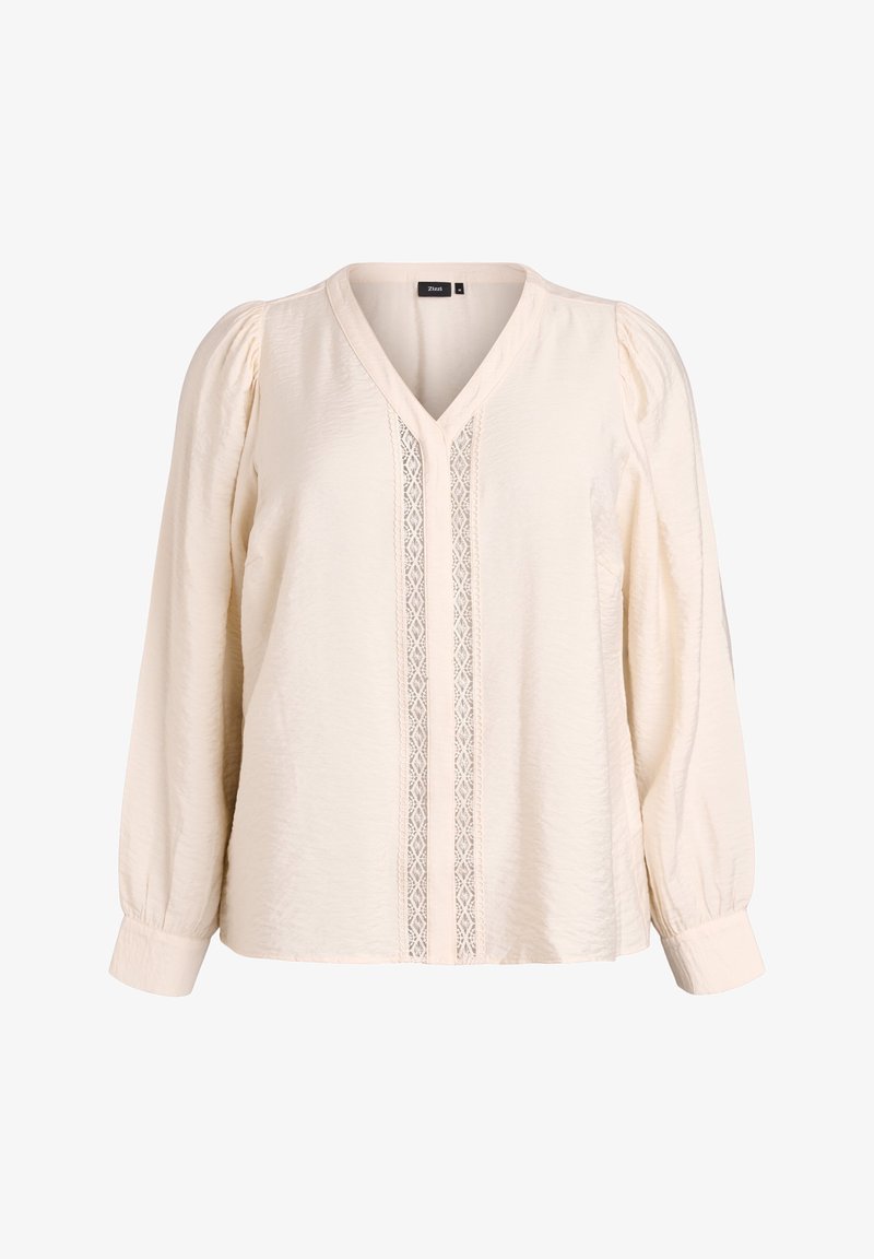 Blouse crème à manches longues avec col en V, bordure en dentelle sur le devant, épaules bouffantes et poignets boutonnés.