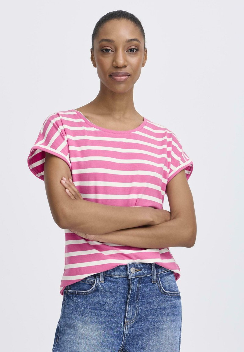 Roosa-valgete triipudega T-särk, millel on üleskeeratud varrukad ning pehmest kangast. Kombineeritud siniste denimist teksadega, mille lõige on klassikaline.