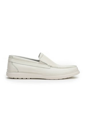 White leather slip-on shoes with a textured surface, rounded toe, and flat rubber sole. Features stitching accents and a low profile design.