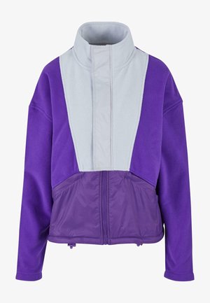 Violetinis flisinis švarkas su pilku intarpų. Turintis aukštą apykaklę, užtrauktuko uždarymą ir dvi apatinės kišenes. Minkšta tekstūra, laisvas kirpimas, stilingas spalvų derinimas.