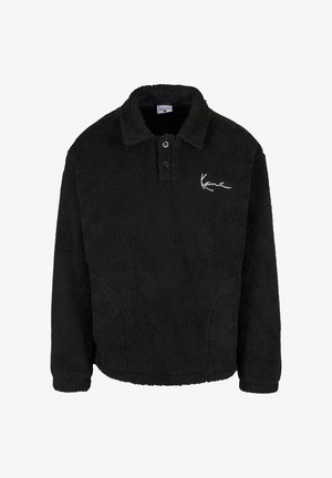 Black fleece pullover with a textured surface, button placket, and a collar. Features a white logo on the left chest area.