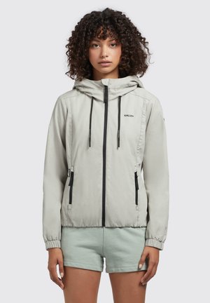 Jachetă zip-up gri deschis, cu glugă, accente negre și manșete elasticizate. Are buzunare laterale și o textură ușoară, netedă.