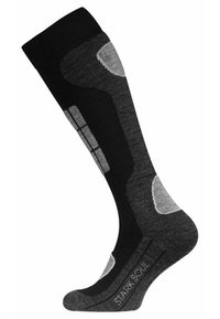 Chaussettes jusqu'aux genoux en noir et gris foncé, dotées d'un design texturé avec des accents gris clair et des zones de rembourrage renforcées. Logo de la marque affiché.