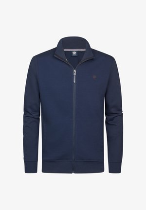 Giacca blu navy con zip frontale, tessuto strutturato, collo alto e maniche lunghe. Presenta un piccolo logo sul petto sinistro e polsini solidi.