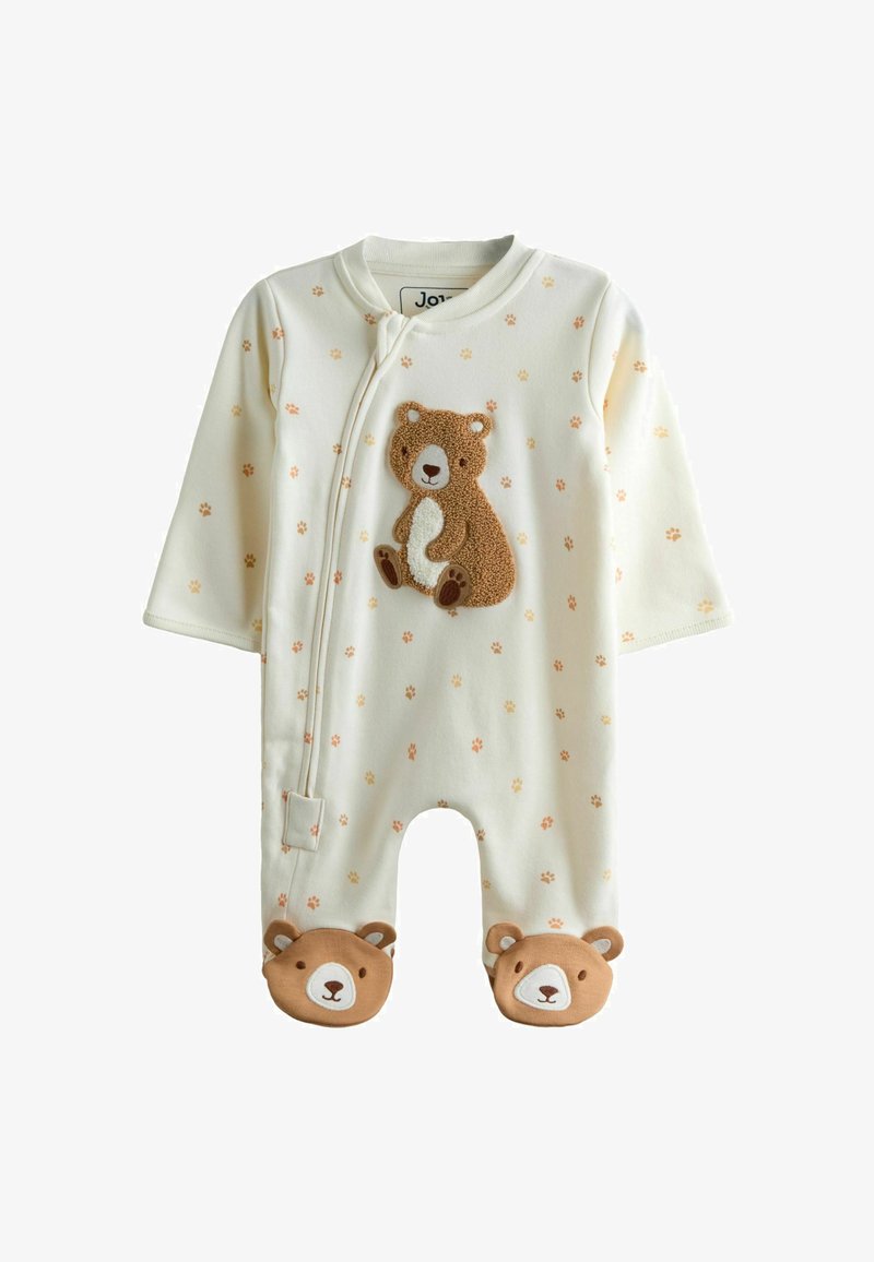 Valge pika varrukaga beebiülikond, millel on karu aplikatsioon, käpajälgede muster ja karupildiga papud. Esiküljel tõmblukuga sulgur.