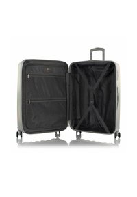 Erweiterbarer Hartschalentrolley mit silberner Außenseite, schwarz ausgekleidetem Innenraum, Reißverschlusstaschen und Kreuzgurten für sichere Aufbewahrung.