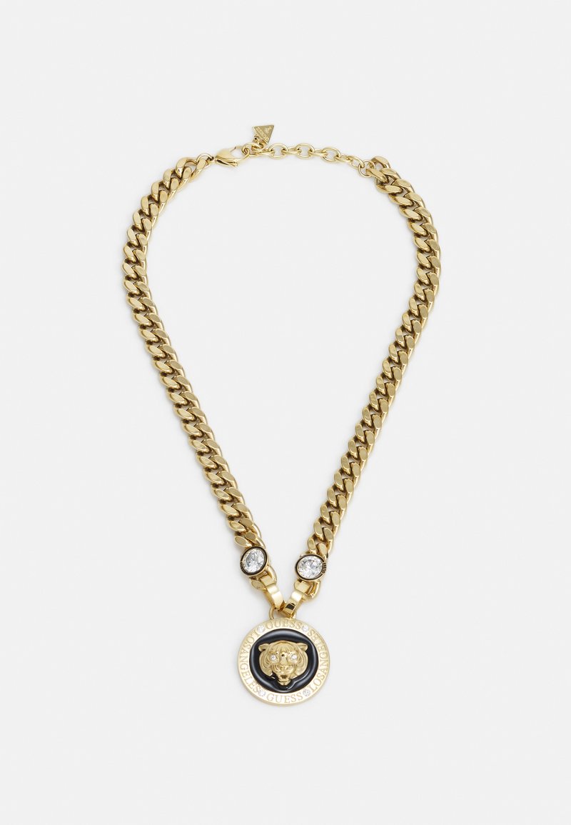 Gouden ketting met een ronde hanger met een leeuwmotief, verfraaid met twee heldere stenen en een zwarte ronde rand.