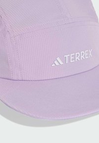 Light purple cap made from textured fabric, featuring a curved visor and the brand name "TERREX" in white on the front.