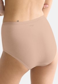 Beige high-waisted briefs made of smooth, stretchy fabric. Features a soft waistband and subtle logo detail near the top.