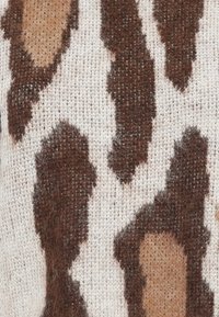 Textured fabric featuring a brown and tan animal print pattern on a light background, with visible fibers and a soft, woven appearance.