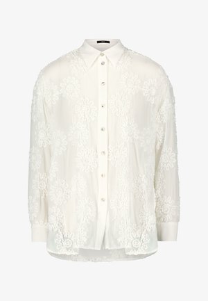 Weiße Bluse aus durchscheinendem Stoff mit bestickten Blumenmustern. Klassischer Kragen und Knopfverschluss mit perlenartigen Knöpfen. Lange Ärmel.