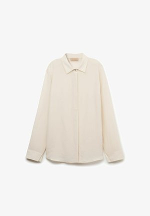 Cremefarvet bluse lavet af glat stof, med en klassisk krave, lange ærmer, en knaplukning fortil og en buet kant.