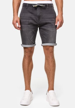 Gray denim shorts with rolled hems, featuring a drawstring waist. Worn with white sneakers; smooth texture, casual design.