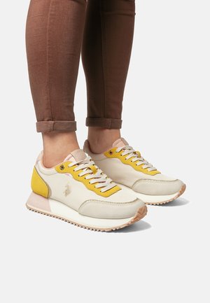 Sneakers with a white, yellow, and pink color scheme. Made of smooth and textured materials. Features laces, a logo, and a rubber sole.