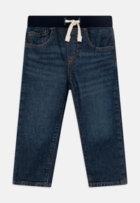 Pantalon en denim bleu foncé avec taille élastique et cordon de serrage. Il comporte un design à cinq poches et des coutures légères le long des bords.