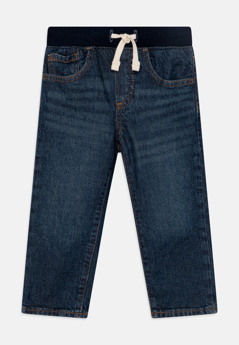 Pantalon en denim bleu foncé avec taille élastique et cordon de serrage. Il comporte un design à cinq poches et des coutures légères le long des bords.