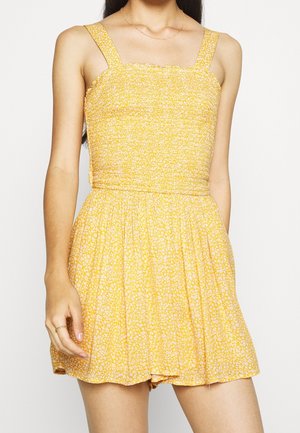 Żółta sukienka w kwiaty z marszczonym gorsetem, kwadratowym dekoltem i szerokimi ramiączkami, z rozkloszowaną spódnicą i lekkim, fakturowanym materiałem.